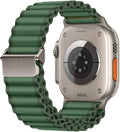 The back view of a titanium Apple Watch Ultra fitted with a rugged, dark green corrugated nylon watch band featuring a silver stainless steel connector and buckle, set against a solid white background.