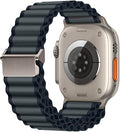 Apple Watch Ultra with a dark grey wide corrugated nylon off-road sports strap and silver metal buckle.