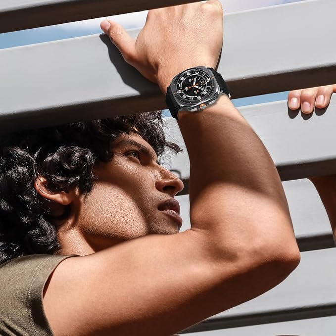 Man looking up while holding onto a structure, wearing an Apple Watch with a black AXYON Alpine Loop-style nylon band.