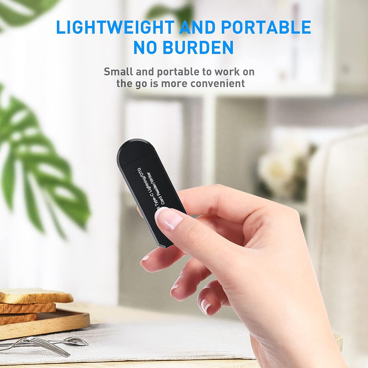 Hand holding a small black device with text about its portability.