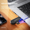 USB card reader connected to a laptop on a wooden surface with text about high number output and compatibility.