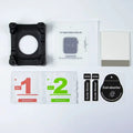 Collection of items including a black case, watch face display, cleaning kit, and stickers on a white background