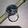 Garmin smartwatch with black face and yellow accents on a gray surface