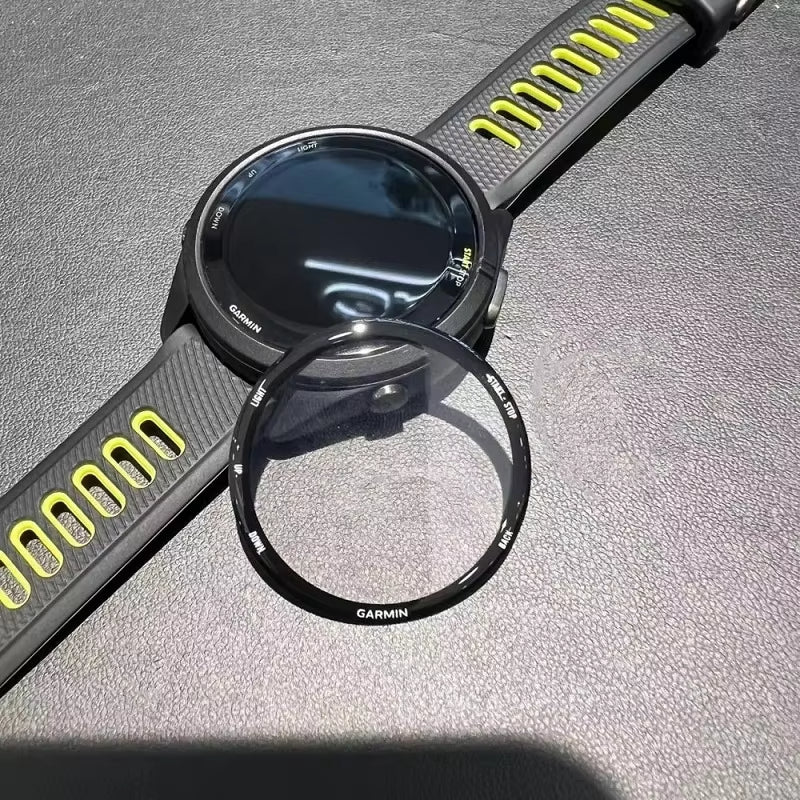 Garmin smartwatch with black face and yellow accents on a gray surface