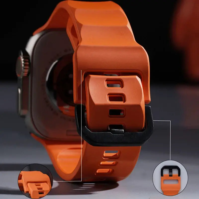 Close-up of an orange smartwatch with a detailed view of its back and charging port.