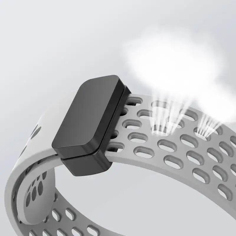 Close-up of a metallic bracelet with a black clasp on a light gray background