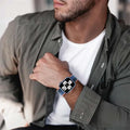 Man wearing a smartwatch on his wrist with a blurred background
