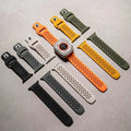 Set of various watch straps on a gray surface