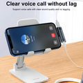 A smartphone resting on a desktop stand during a voice call with an AXYON 2-in-1 USB-C adapter connected, showing simultaneous charging and wired headphone connection.