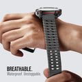 Person wearing a smartwatch with a breathable strap on a light gray background