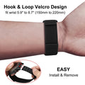 Black velcro strap on a wrist with text indicating size range and ease of installation.