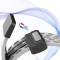 Black magnetic sensor device attached to a white hose with a blue and red magnet nearby on a light purple background.