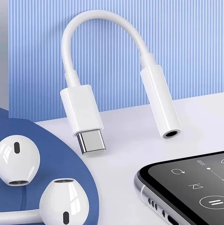 White USB-C adapter with a smartphone and earbuds on a light blue background