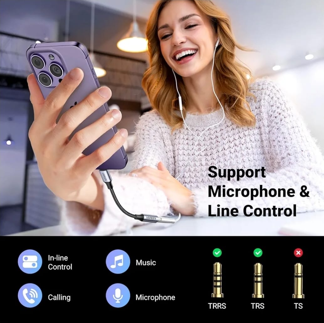 Woman using a smartphone with earphones, smiling, in an indoor setting.