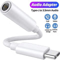 White audio adapter with Type-C to 3.5mm audio connection on a white background