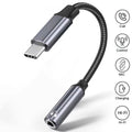 USB-C to 3.5mm audio adapter with flexible cable on a white background