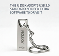 Silver USB drive with keychain attachment on a white background, featuring text about USB 3.0 standard and software compatibility.